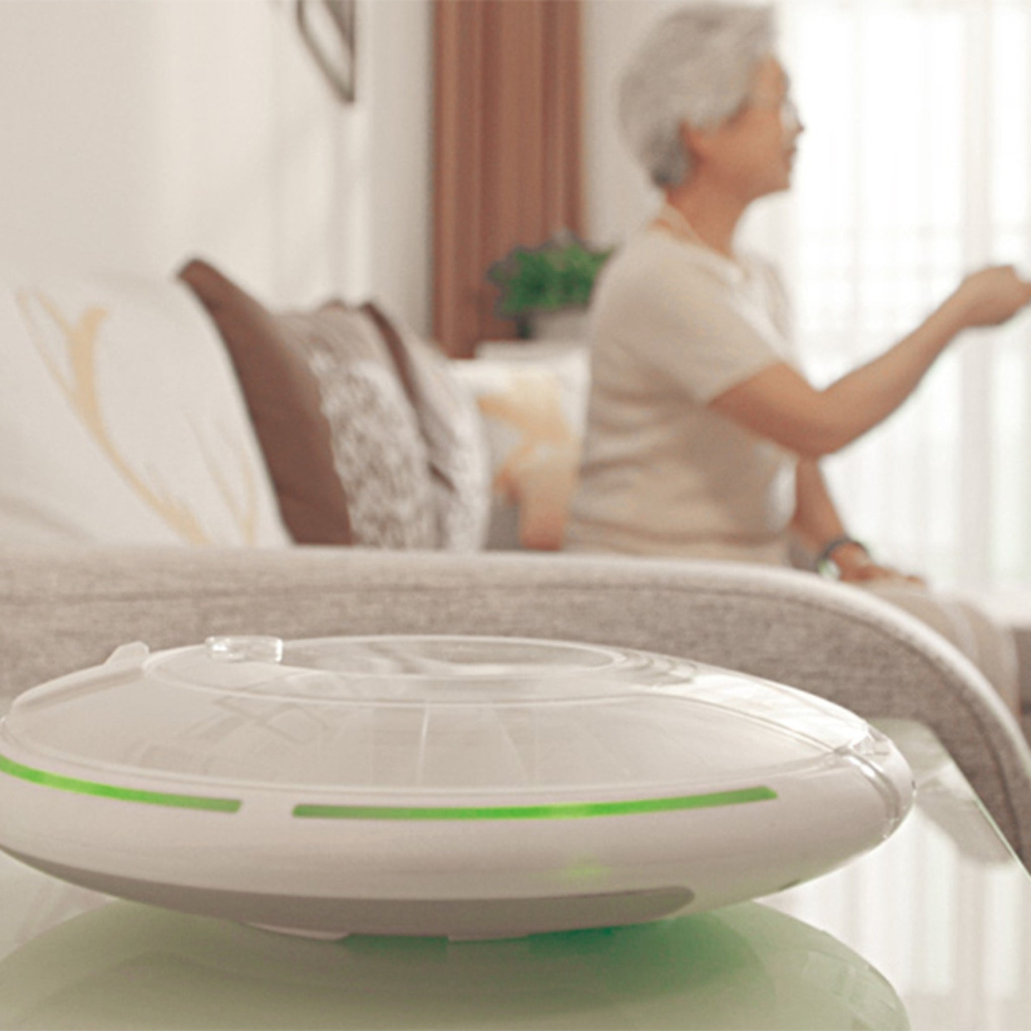 Senior lady sitting on couch behind Medforte Automatic Pill Dispenser